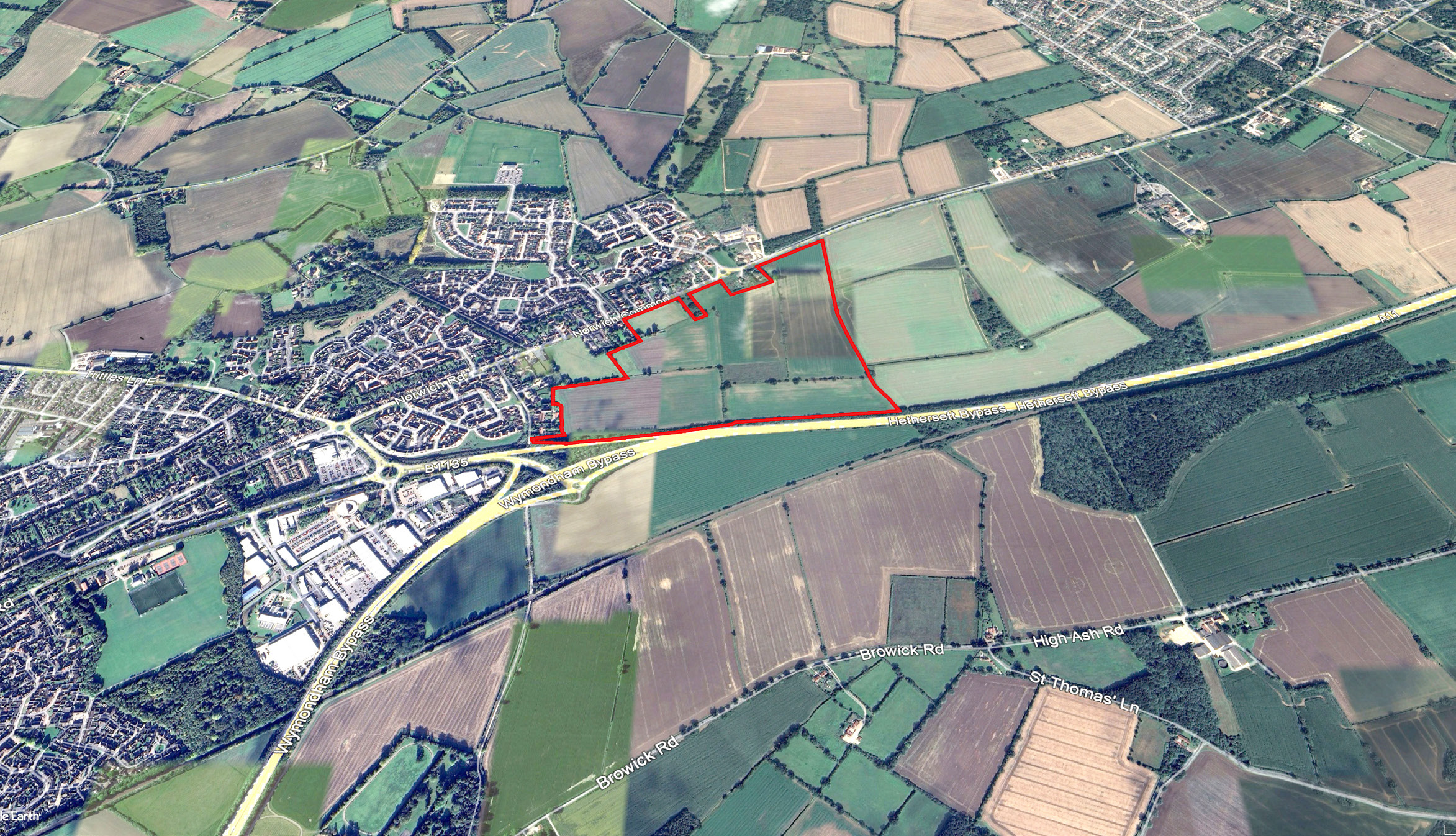Aerial image showing the proposed development site marked by a red boundary between Norwich Common and the A11